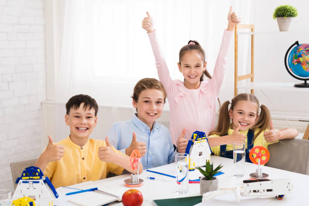 istock Stem education. Happy children showing thumbs up 1172152372