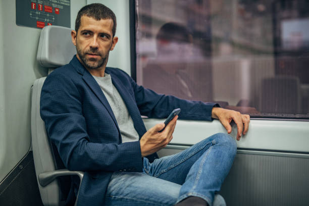 istock Man riding in subway train and using phone 1172154456