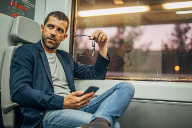 istock Gentleman riding in train and using phone 1172154474