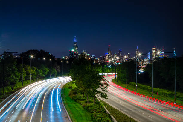 Lights in the city at night. Skyline and traffic on the streets of Chicago. Lights in the city at night. Skyline and traffic on the streets of Chicago, Illinois. lake shore drive chicago stock pictures, royalty-free photos & images