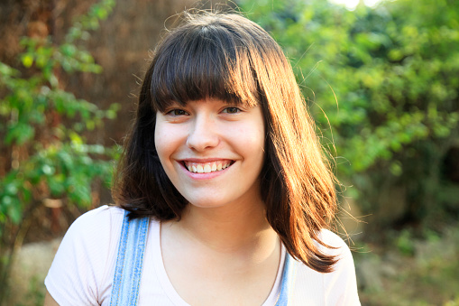 Portrait of cheerful young woman outdoors