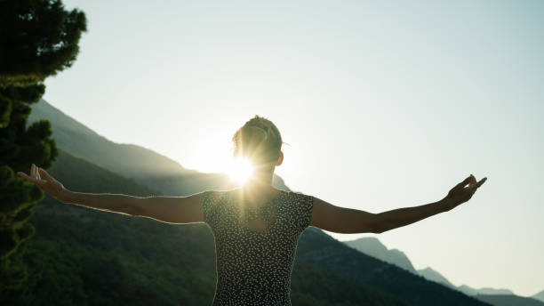 istock Woman greeting sunrise 1172156103