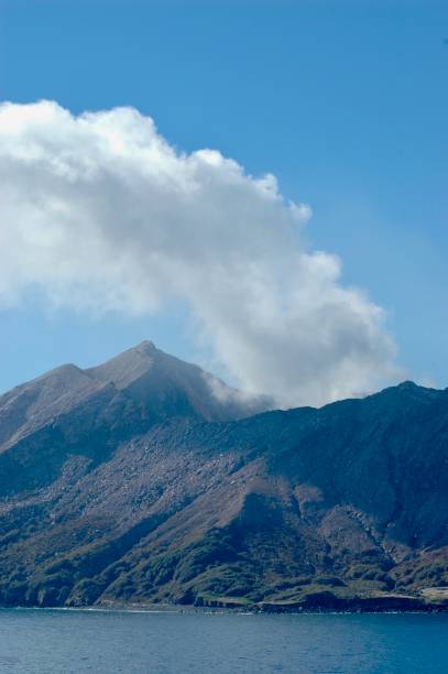 istock A smoking volcano, seen from the sea. 1172157044