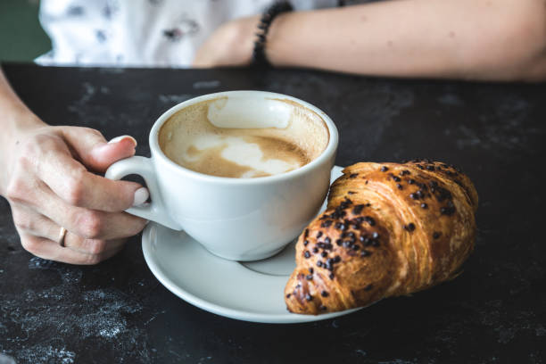istock Cup of cappuccino and croissant 1172158474