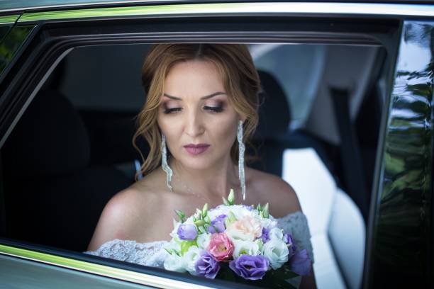 istock The bride is sitting in a car. 1172159807