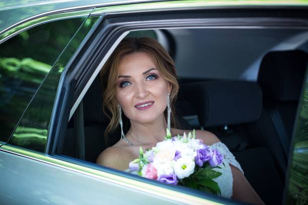 istock The bride is sitting in a car. 1172159848