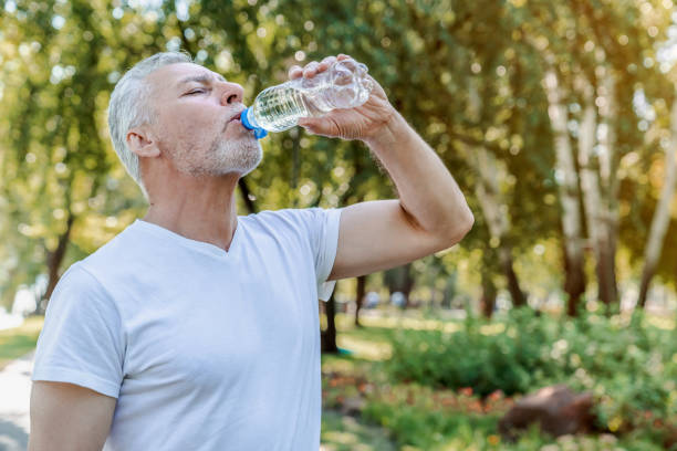 istock Senior man drinking water after workout in park. 1172160881