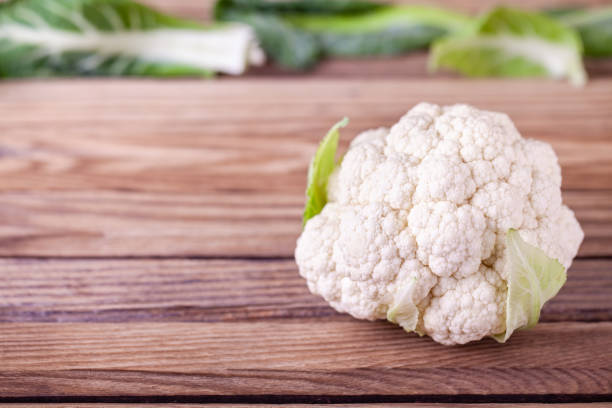 istock Raw cauliflower on wooden background 1172160939