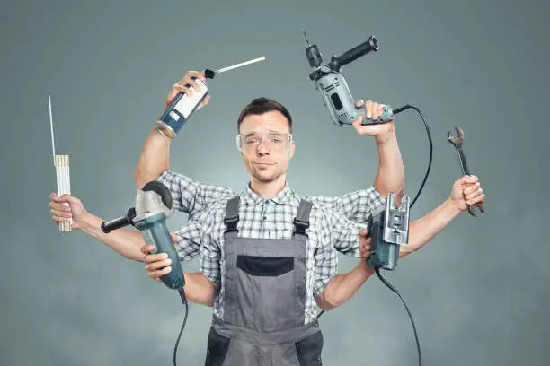 Photo of Funny portrait of a craftsman with 6 arms