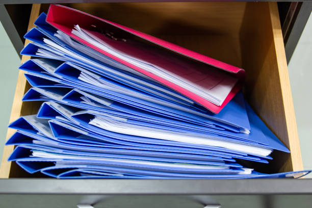 istock Hand of Man Search files document in a file cabinet in work office 1172164451