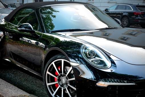Hamburg, Germany - August 30. 2019: A black Porsche 911 cabriolet parked on the street, somewhere in Hamburg - Germany
