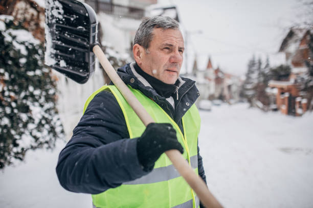 Senior man going to clean snow One man, prepared to clean the street full on snow, holding snow shovel. winterdienst stock pictures, royalty-free photos & images