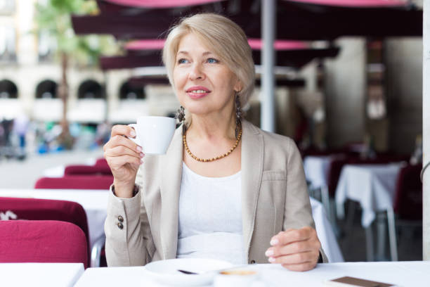 istock Mature businesswoman is drinking coffee 1172166382