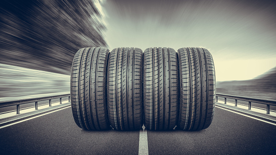 Group of car tires on an asphalt road.