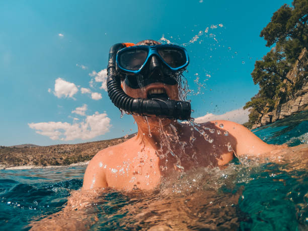 Diver emerge from the sea