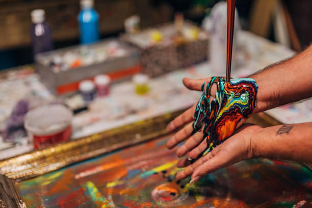 istock Artist mixing colors on his hands 1172169094