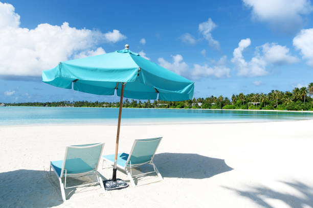 istock Tropical paradise beach with lounge chairs and umbrella 1172175254