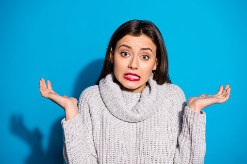 Pretty lady listening parents blaming wear knitted pullover isolated blue background