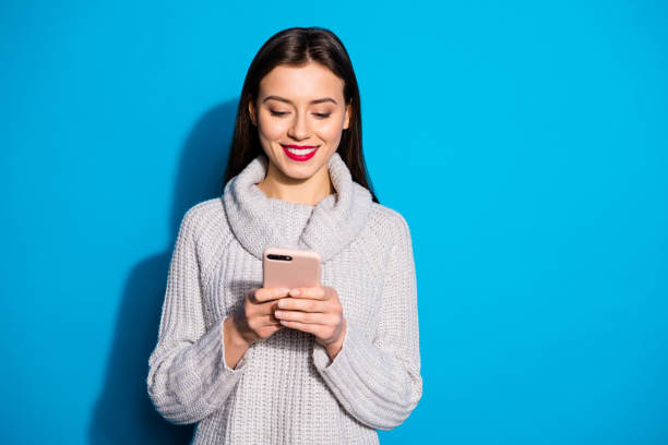 istock Pretty lady holding telephone hands wear warm knitted pullover isolated blue background 1172175988