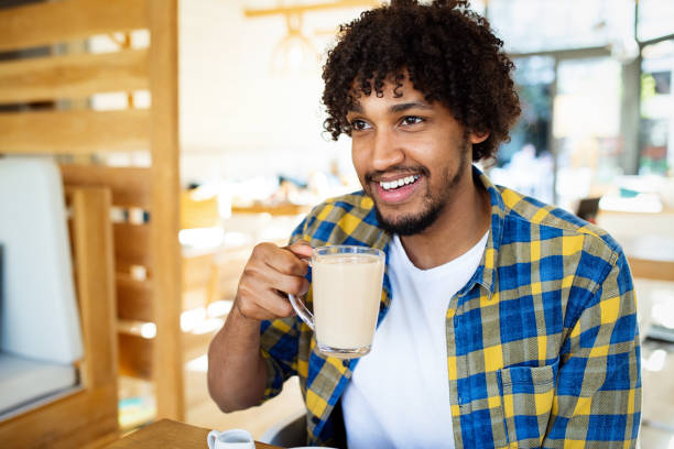 istock Happy handsome black man drinking coffee and smiling 1172176301