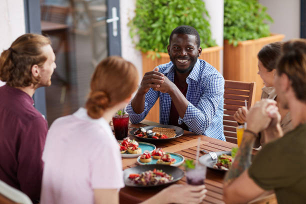 istock Diverse Group of Friends Enjoying Lunch Together 1172176488