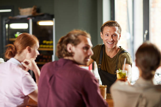 istock Cheerful Man Enjoying Lunch with Friends in Cafe 1172176509