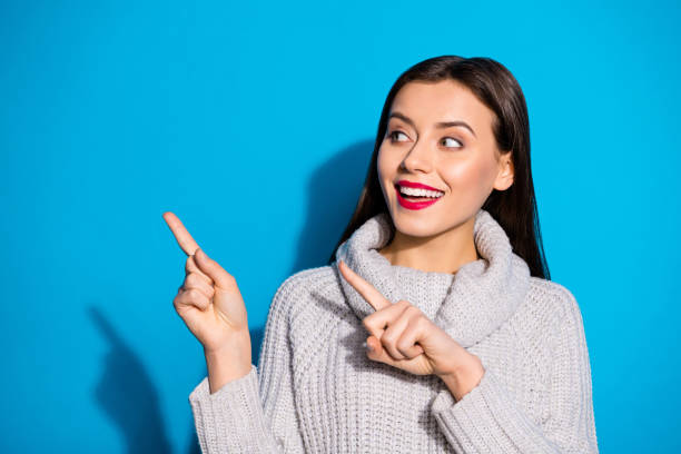 istock Photo of wondered lady indicating arms empty space wear warm knitted pullover isolated blue background 1172176763