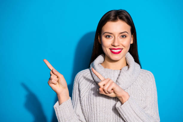 istock Photo of pretty lady indicating arms empty space wear warm knitted pullover isolated blue background 1172177143
