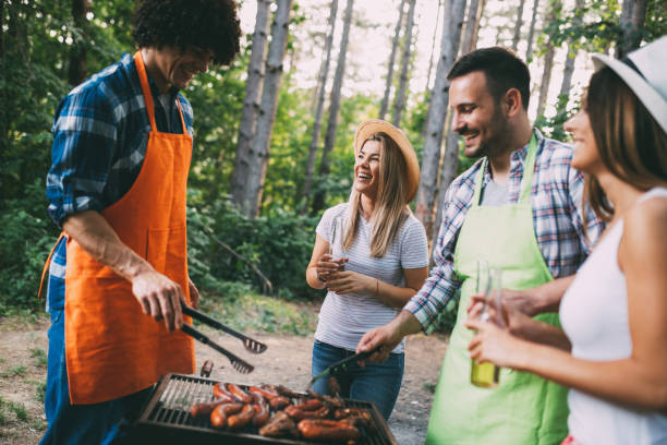 istock Friends having a barbecue party in nature while having fun 1172177281