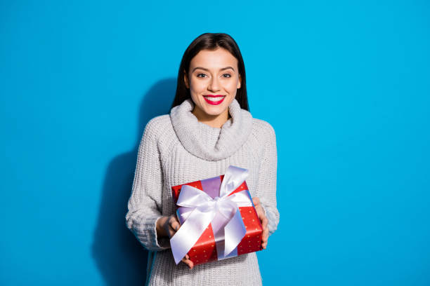 istock Petty lady taking big red giftbox wear knitted pullover isolated blue background 1172177321
