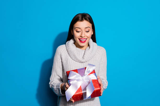 istock Petty lady holding hands big red giftbox wear knitted pullover isolated blue background 1172177344