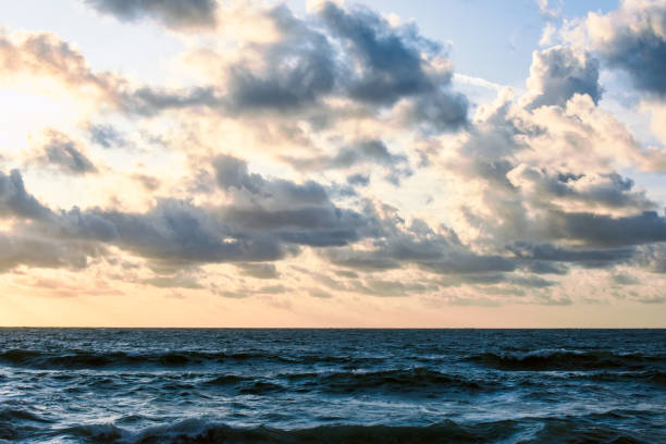 istock The ocean, rough sea water with horizon and clouds during evening sunset 1172183472