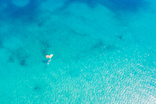 Drone view of swimming woman