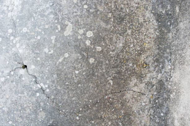 istock close up on real old concrete wall, cracked and dirty with small hole 1172185700