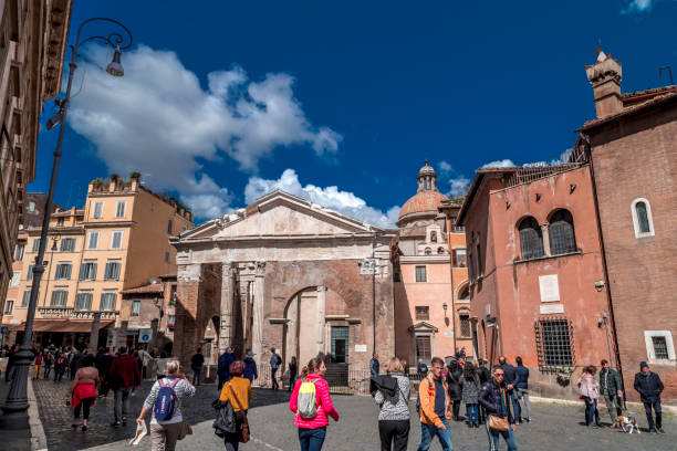 The old Jewish Ghetto of Rome Rome, Italy - April 7, 2019: View from the old Jewish Ghetto of Rome on April 7, 2019. Pillars of Porticus Octaviae, the Port of Octavia and people walking around. porticus stock pictures, royalty-free photos & images