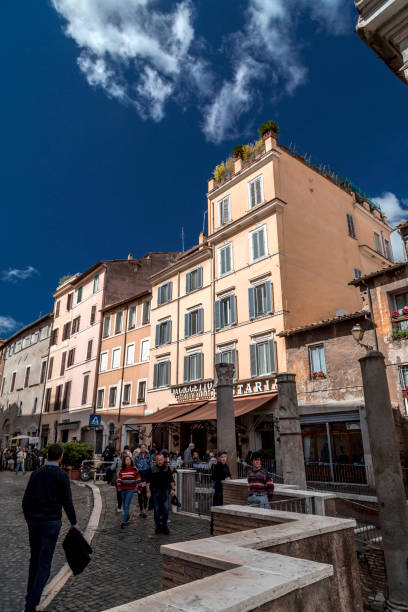 The old Jewish Ghetto of Rome Rome, Italy - April 7, 2019: View from the old Jewish Ghetto of Rome on April 7, 2019. Pillars of Porticus Octaviae, the Port of Octavia and people walking around. porticus stock pictures, royalty-free photos & images