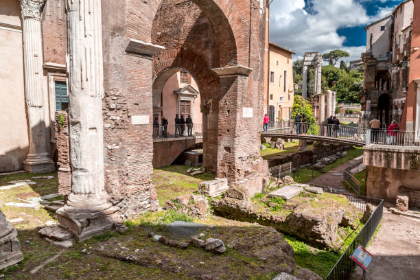 The old Jewish Ghetto of Rome Rome, Italy - April 7, 2019: View from the old Jewish Ghetto of Rome on April 7, 2019. Pillars of Porticus Octaviae, the Port of Octavia and people walking around. porticus stock pictures, royalty-free photos & images