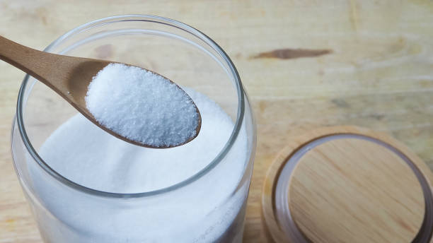 istock Granulated sugar on a wooden spoon 1172188300