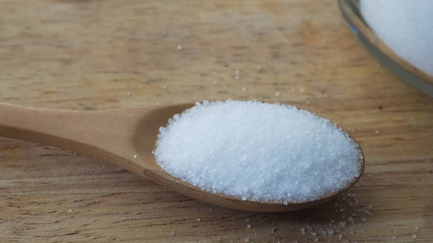 istock Granulated sugar on a wooden spoon 1172188318