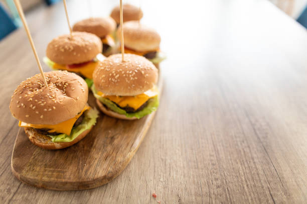 istock Delicious burgers on dining table 1172194048