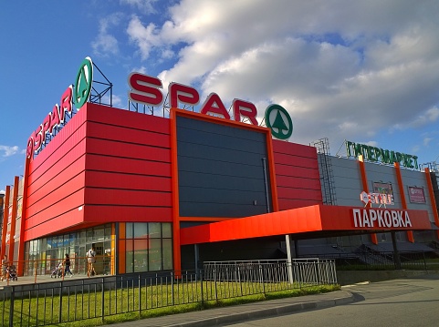 St. Petersburg, Russia - September 3, 2019: Building of top Russian Supermarket SPAR is one of largest players of retail industry in Russia. Modern facade in red.
