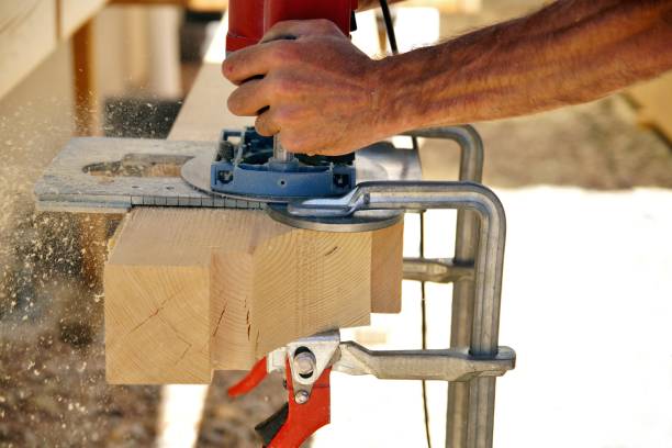 istock Dovetail joint. a man's hands is working with a milling machine. milling Woodworking and carpentry production. Wooden beams spruce for outdoor construction. 1172199245