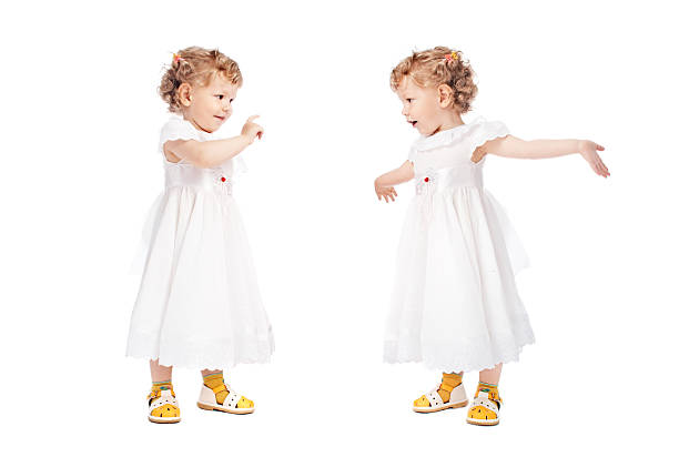 Low section of a little girl standing on floor and wearing slipper with socks.