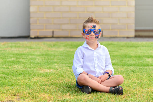 smiling male caucasian Toddler looking at the camera wearing sunglasses