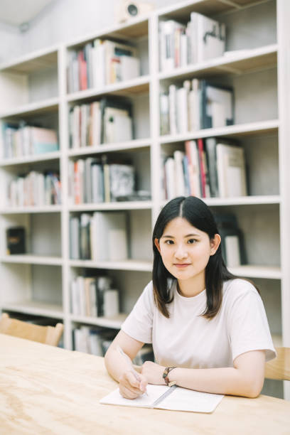 istock Smiling Asian woman studying in Library 1172201241