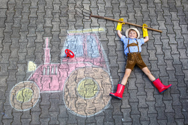 istock little kid boy having fun with tractor chalks picture 1172203349