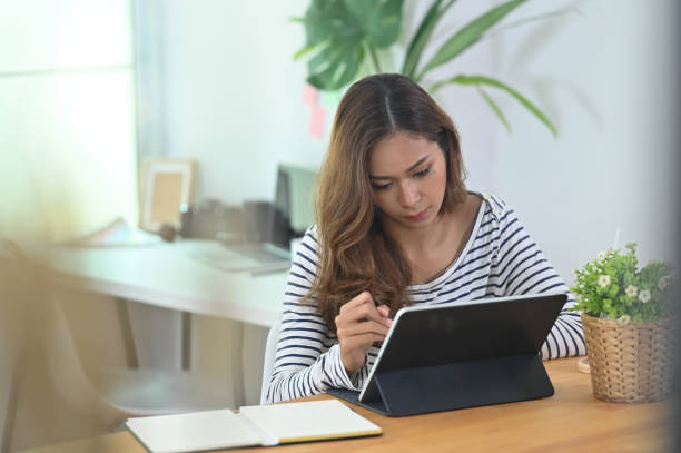 istock Woman creative working with tablet in artist workspace. 1172203373