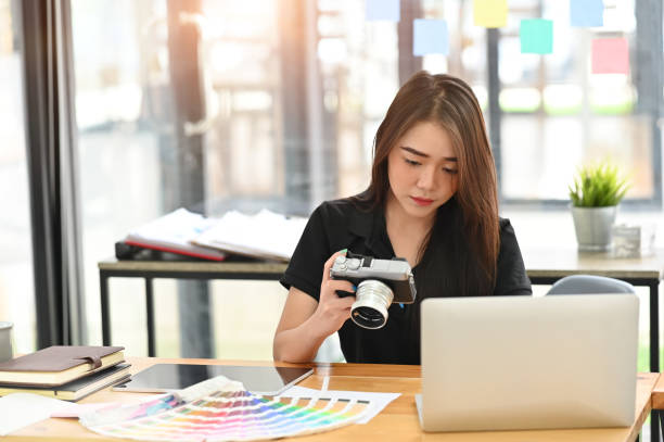 istock Young creative female working with camera on artist workplace. 1172203398