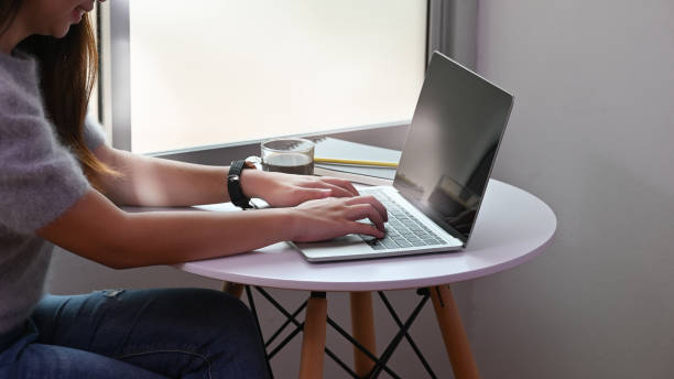 istock Close-up female typing laptop computer on table. 1172204484