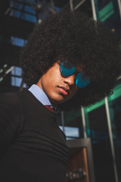 istock Young male with Afro hairstyle looking at camera 1172205570